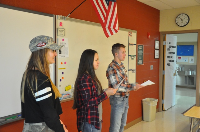 Gracie Assion, Emily Williams, and Sean Lengyel help with SADD activities in the middle school.