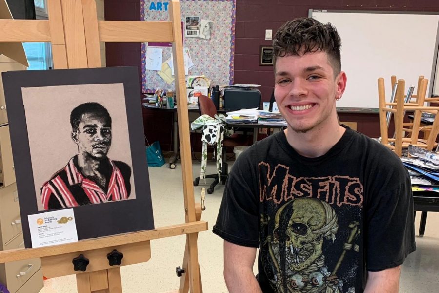 David Vega pictures with his artwork